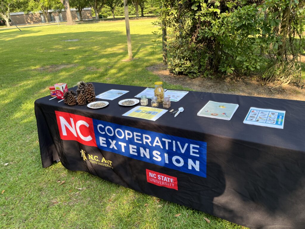 A table set up to discuss birding and bird feeders. 